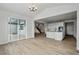 Dining room with hardwood floors, and views into kitchen and living areas at 3242 Boral Owl Dr, Brighton, CO 80601