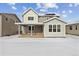 Two-story home with backyard deck and snowy yard at 3242 Boral Owl Dr, Brighton, CO 80601