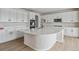 Modern kitchen with white cabinetry and a large quartz island at 3242 Boral Owl Dr, Brighton, CO 80601