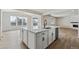 Open concept kitchen island with white cabinets and stainless steel appliances at 3242 Boral Owl Dr, Brighton, CO 80601