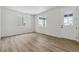 Bright living room featuring light hardwood floors and neutral walls at 3242 Boral Owl Dr, Brighton, CO 80601