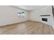 Spacious living room with hardwood floors and a corner fireplace at 3242 Boral Owl Dr, Brighton, CO 80601