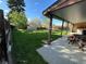 Backyard view showing patio, shed, and grass at 1851 S Perry Way, Denver, CO 80219