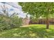 Yard with lush grass, shed, and large tree at 1851 S Perry Way, Denver, CO 80219