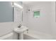 Updated bathroom with white subway tile, pedestal sink, and bathtub at 1851 S Perry Way, Denver, CO 80219