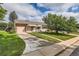 Nice curb appeal, landscaped lawn, and attached garage at 1851 S Perry Way, Denver, CO 80219