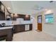 Modern kitchen features dark cabinets, white tile backsplash, and stainless steel appliances at 1851 S Perry Way, Denver, CO 80219