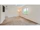 Spacious living room with neutral walls and carpeting, plus a large window at 1851 S Perry Way, Denver, CO 80219