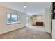 Bright and airy living room with neutral carpeting and built-in shelves at 1851 S Perry Way, Denver, CO 80219