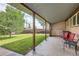 Covered patio with chairs and view of backyard at 1851 S Perry Way, Denver, CO 80219