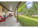 Covered patio area with seating and backyard access at 1851 S Perry Way, Denver, CO 80219