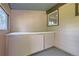 Small storage room with pegboard walls and cabinets at 1851 S Perry Way, Denver, CO 80219