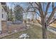 Backyard features a stone patio, wooden fence, and mature trees creating a private outdoor space at 16364 Flintlock Ct, Parker, CO 80134