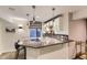 Modern bar area with granite countertops, pendant lighting, and stylish cabinetry at 16364 Flintlock Ct, Parker, CO 80134