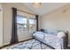 Cozy bedroom with two windows offering beautiful views, gray curtains, and a cute single bed at 16364 Flintlock Ct, Parker, CO 80134