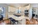 Modern kitchen featuring white cabinetry, an island cooktop, and stainless steel appliances at 16364 Flintlock Ct, Parker, CO 80134