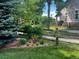 Beautifully landscaped yard with a wooden fence, flower beds, and lush greenery at 16364 Flintlock Ct, Parker, CO 80134