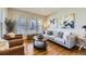 Cozy living room featuring hardwood floors, comfortable seating, and lots of natural light at 16364 Flintlock Ct, Parker, CO 80134