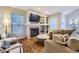 Inviting living room featuring a fireplace, built-in shelves, hardwood floors, and comfortable seating at 16364 Flintlock Ct, Parker, CO 80134