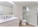 Bathroom featuring white vanity, modern fixtures, and a glass-enclosed shower with subway tile surround at 3315 S Ammons St # 103, Lakewood, CO 80227