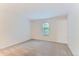 Bright, carpeted bedroom featuring a window with natural light and neutral walls at 3315 S Ammons St # 103, Lakewood, CO 80227