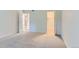 Neutral bedroom with a walk-in closet and connecting hallway visible through open doorways at 3315 S Ammons St # 103, Lakewood, CO 80227