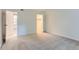 Spacious bedroom leading to an en-suite bathroom and large closet space, carpeted and painted white at 3315 S Ammons St # 103, Lakewood, CO 80227