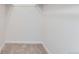 Walk-in closet with carpeted flooring and white walls and shelves, providing ample storage space at 3315 S Ammons St # 103, Lakewood, CO 80227