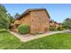 Property shows brick and siding and a meticulously landscaped lawn, creating a welcoming and attractive exterior at 3315 S Ammons St # 103, Lakewood, CO 80227