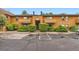 Property featuring well-maintained landscaping, parking spaces, and a classic architectural design at 3315 S Ammons St # 103, Lakewood, CO 80227