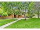Beautiful condo complex with lush green lawn and mature trees offering a serene living environment at 3315 S Ammons St # 103, Lakewood, CO 80227
