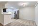 Bright kitchen area with stainless steel refrigerator and ample counter space, adjacent to a cozy living space at 3315 S Ammons St # 103, Lakewood, CO 80227