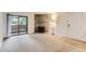Inviting living room featuring neutral carpet, fireplace, and sliding glass door access to the outside at 3315 S Ammons St # 103, Lakewood, CO 80227