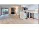 Open-concept space connecting the living room with fireplace to the modern kitchen at 3315 S Ammons St # 103, Lakewood, CO 80227