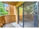 Balcony view featuring a sliding glass door and wooden railing, inviting natural light and serene outdoor views at 3315 S Ammons St # 103, Lakewood, CO 80227