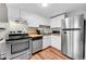Bright kitchen featuring white cabinets, stainless steel appliances, and tile backsplash at 655 N Pearl St # 108, Denver, CO 80203