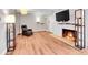 Spacious living room featuring laminate floors and a cozy fireplace at 655 N Pearl St # 108, Denver, CO 80203