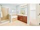 Bathroom with a double vanity, soaking tub, and glass-enclosed shower at 7777 E 23Rd Ave # 1401, Denver, CO 80238