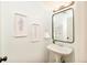 Chic powder room with pedestal sink and decorative wall art at 7777 E 23Rd Ave # 1401, Denver, CO 80238