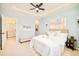 This spacious bedroom features neutral walls, stylish decor, and plush white bedding at 7777 E 23Rd Ave # 1401, Denver, CO 80238