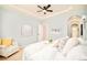 Bedroom with neutral walls, cozy white armchair, and plush white bedding at 7777 E 23Rd Ave # 1401, Denver, CO 80238