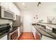 Well-equipped kitchen featuring stainless steel appliances and hardwood floors at 7777 E 23Rd Ave # 1401, Denver, CO 80238