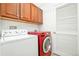Laundry room with overhead cabinets, washer, and dryer at 7777 E 23Rd Ave # 1401, Denver, CO 80238