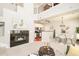Open-concept space featuring a modern fireplace, a well-equipped kitchen, and a lofted seating area above at 7777 E 23Rd Ave # 1401, Denver, CO 80238