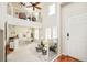 Sunlit living area with soaring ceilings, a cozy fireplace, and an open layout connecting to the dining space at 7777 E 23Rd Ave # 1401, Denver, CO 80238