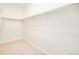 A walk-in closet with white walls, carpet, and hanging racks at 7777 E 23Rd Ave # 1401, Denver, CO 80238