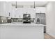 Modern kitchen with white cabinets, quartz countertops, and stainless steel appliances at 3955 W 13Th Ave, Denver, CO 80204