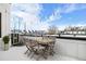 Relaxing rooftop deck features a table, chairs, and city views at 3955 W 13Th Ave, Denver, CO 80204