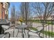 Cozy balcony featuring a wrought iron railing, stylish outdoor furniture, and a table with a floral centerpiece at 76 S Garfield St, Denver, CO 80209
