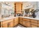 Bathroom featuring double sinks, tile countertops, and ample storage space at 76 S Garfield St, Denver, CO 80209